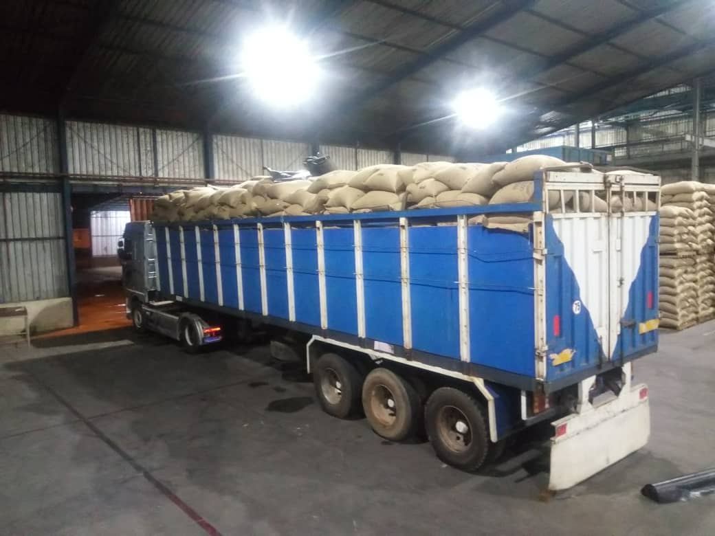 Truck being loaded with sacks inside a warehouse